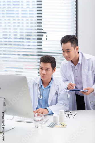 Two doctors discussing a patient s medical records