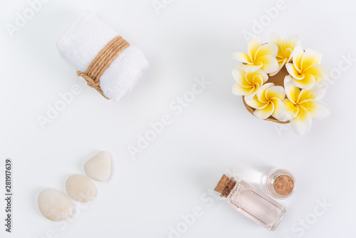 Spa concept,white towels,rose liquid soap,Plumeria flower and zen stone over white background,top view with space for text