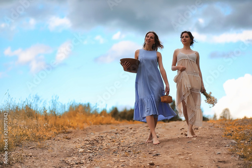 Two girls in dresses in autumn field © alexkich