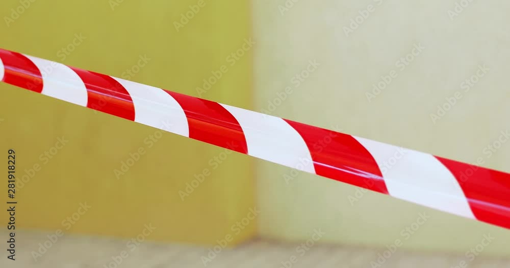 White and red protective tape at wind front of blurred wall White and red protective tape at wind front of blurred wall