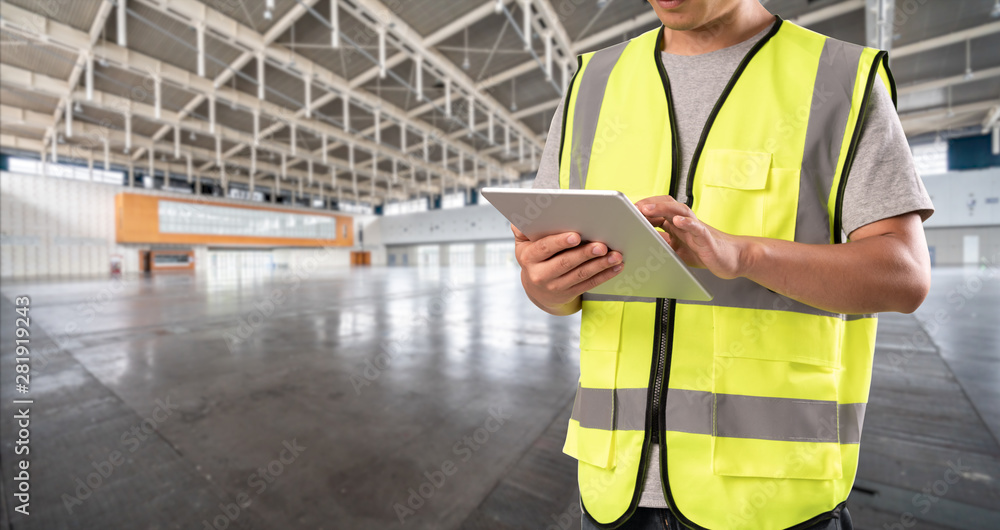 worker hand holding pad for check order pick time in empty warehouse worker hand holding pad for check order pick time in empty warehouse