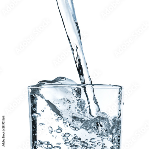 The stream of water pouring into a glass close-up isolated on white background