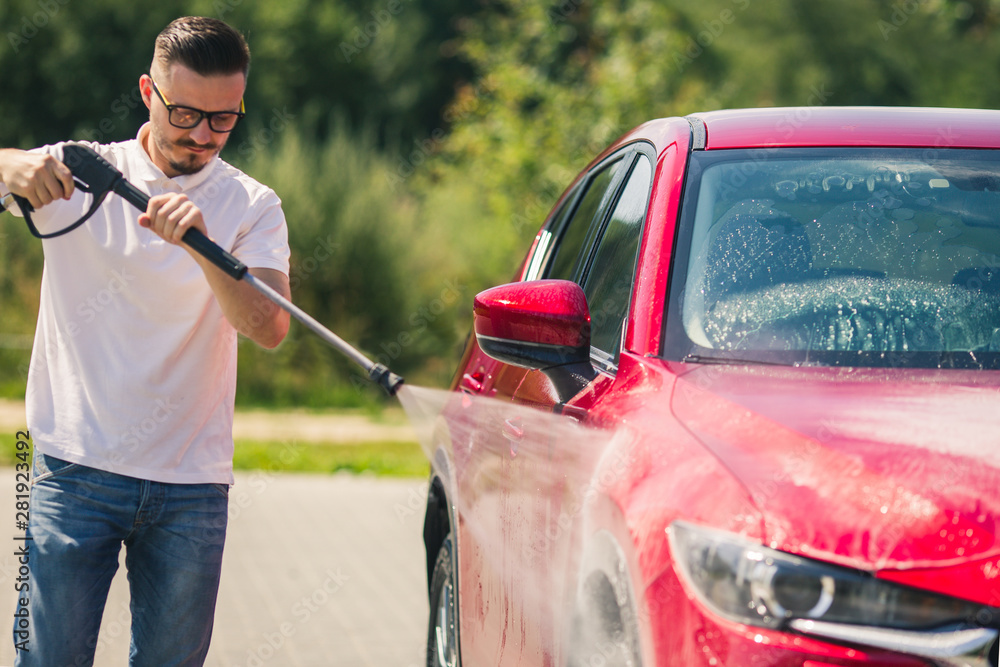 Manual car wash with pressurized water in car wash outside. Summer Car