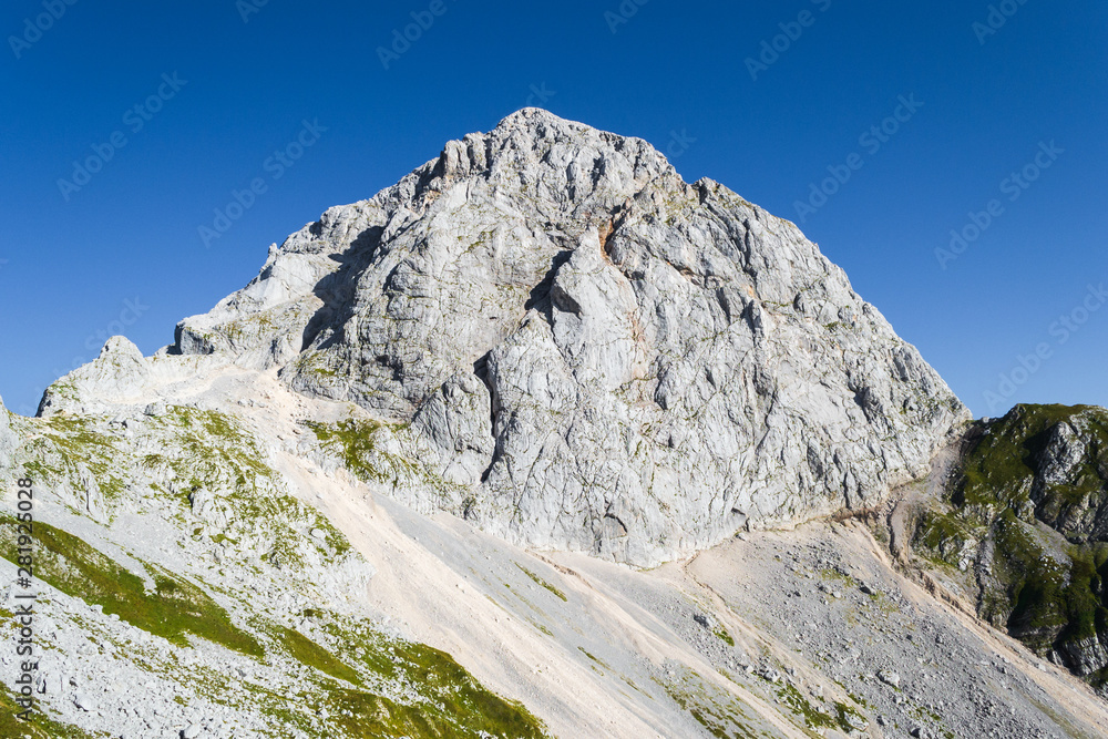 Mangart (or Mangrt) peak, a mountain in the Julian Alps, located on the border between Italy and Slovenia. At 2,679 metres high, it is the third-highest peak in Slovenia.