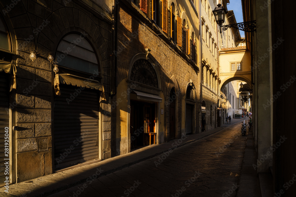 Narrow street in Florence city, Italy in the sunset