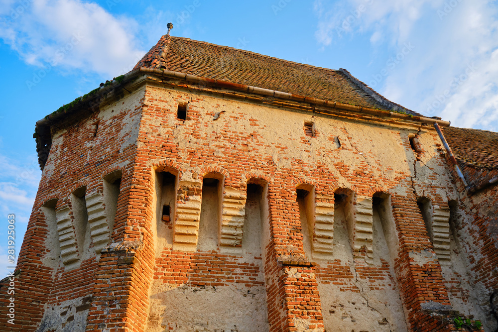 Alma Vii Fortified Church with warm sunset light. Popular touristic destination in Transylvania, Romania.