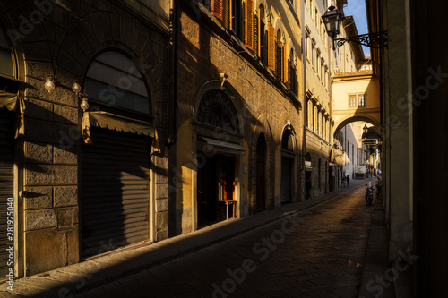 Narrow street in Florence city, Italy in the sunset