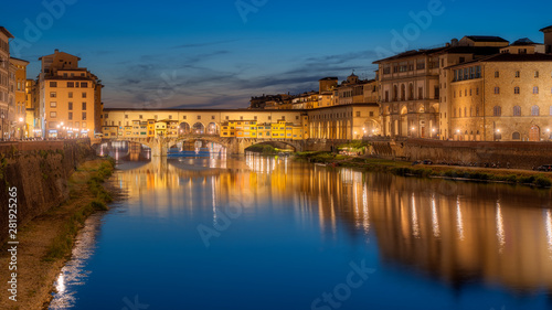 Ponte Vecchio bridge over Arno river in Florence city, Italy in the sunset