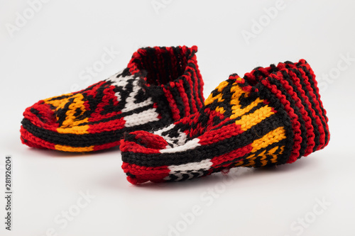 Colored knitted slippers on a white background.