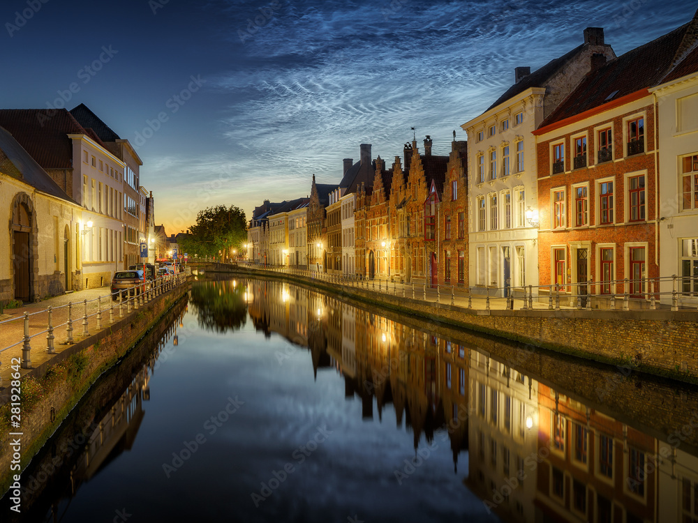 Noctilucent clouds (night shining clouds) at city Bruges (Brugge) old town in Belgium in the dusk, Europe