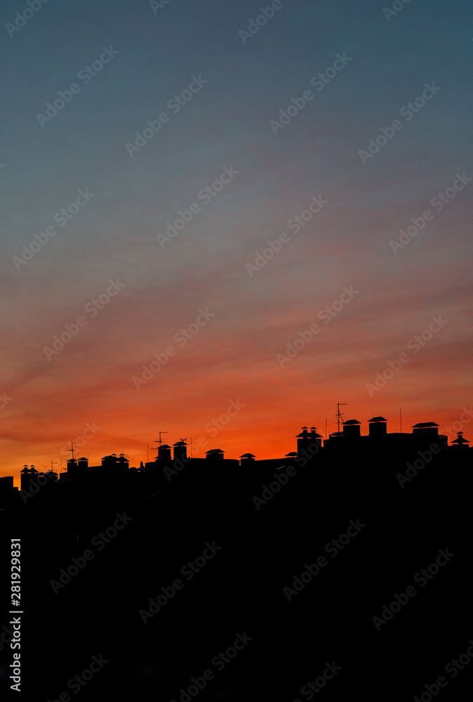 Roofs of houses on a background of a beautiful sunset
