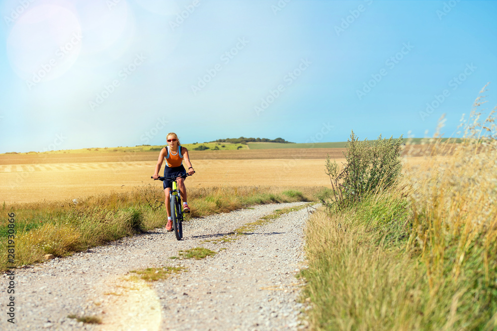 beautiful athletic young woman doing mountain bike