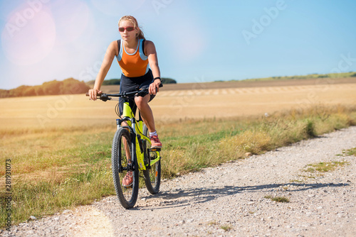 beautiful athletic young woman doing mountain bike