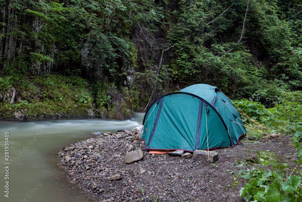 Tourist tent in the mountains next to the river