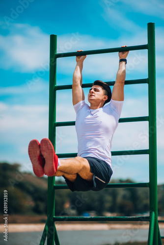 Young athletic man is exercising abs workout