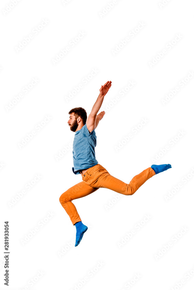 Young hip hop dancer performing jumping isolated over a white background