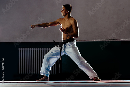 Taekwondo action isolated by a young silhouette man