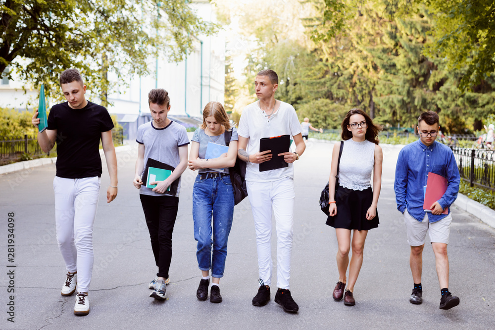 Group of disappointed and upset students going from the university. Poor youngsters have failed team project and feel terrible Group of disappointed and upset students going from the university. Poor youngsters have failed team project and feel terrible