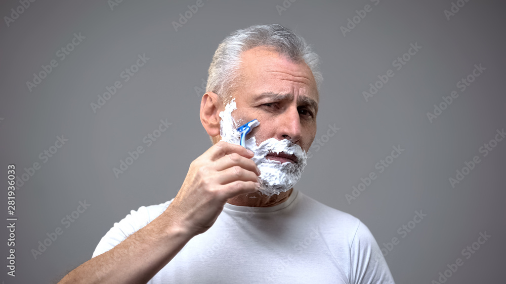 Senior male shaving, aging skincare cream, morning routine rituals, tradition Senior male shaving, aging skincare cream, morning routine rituals, tradition