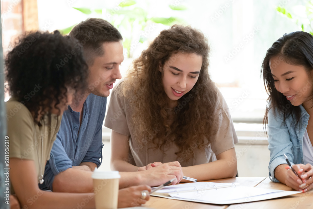 Different ethnicity businesspeople or students working together on project Different ethnicity businesspeople or students working together on project
