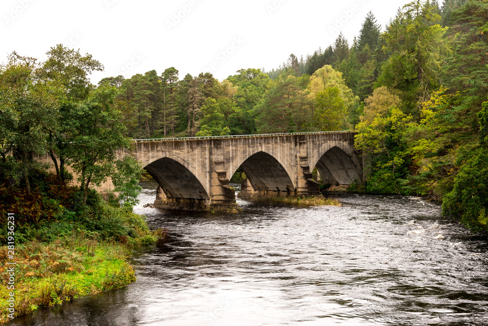 A bridge over River Oich next to the swing bridge and historic Bridge of Oich at Aberchalder, Scottish Highlands