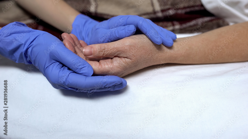 Nurse supporting and calming down patient before procedure caring hospital staff Nurse supporting and calming down patient before procedure caring hospital staff