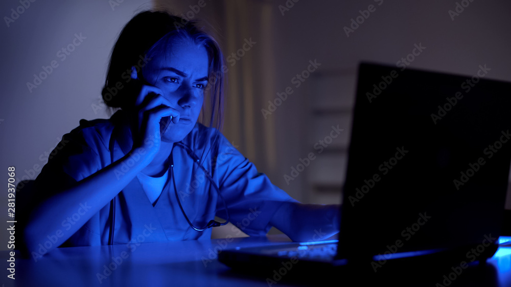 Ambulance operator taking call and filling medical card of patient, 911 service Ambulance operator taking call and filling medical card of patient, 911 service
