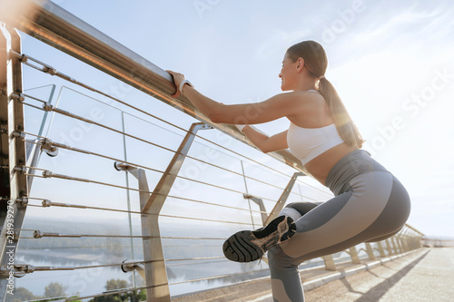 Young athletic lady doing one legged squat © Yakobchuk Olena