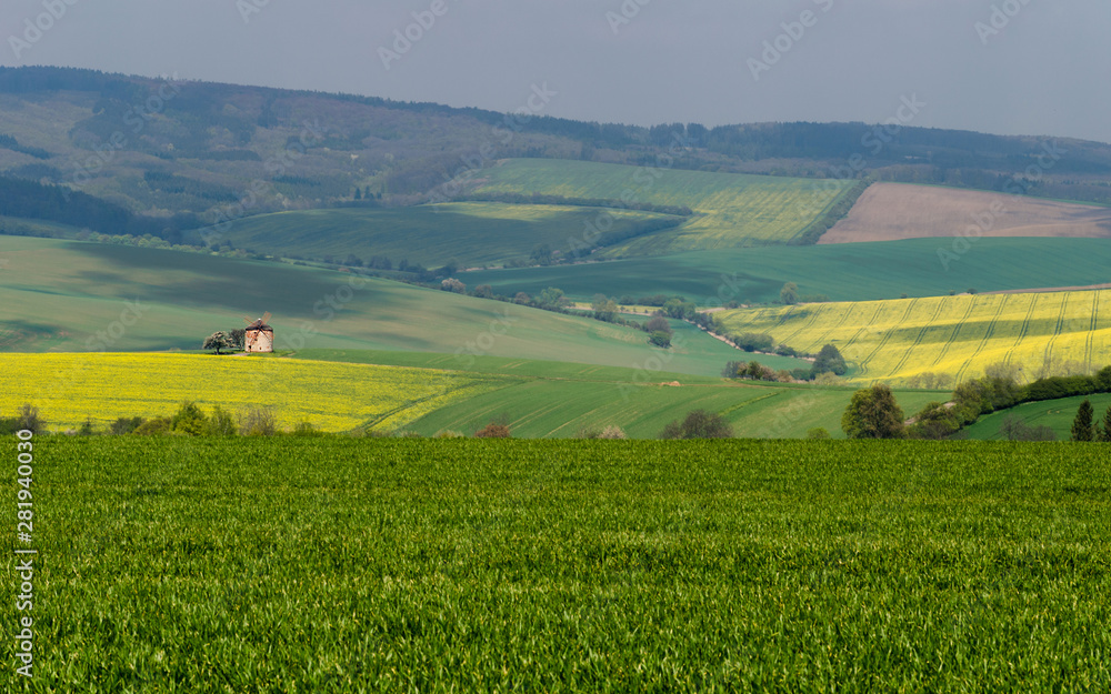 Rural abstract landscape with rolling hills and windmill in South Moravia, Czech Republic Rural abstract landscape with rolling hills and windmill in South Moravia, Czech Republic
