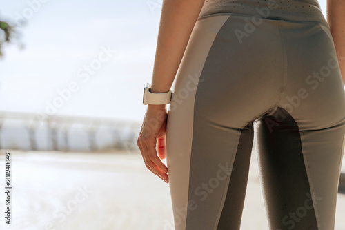 Close up of young athletic lady in sport pents photo