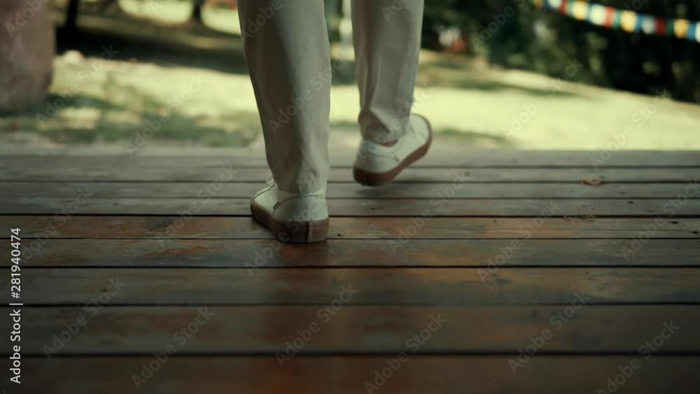 Man Walking In Beautiful Place.Stylish Businessman Walking In Buddhist Tample.Man Wearing Elegant Suit And Shoes.Man Foots Moving In Wooden Floor. Man Walking In Beautiful Place.Stylish Businessman Walking In Buddhist Tample.Man Wearing Elegant Suit And Shoes.Man Foots Moving In Wooden Floor.