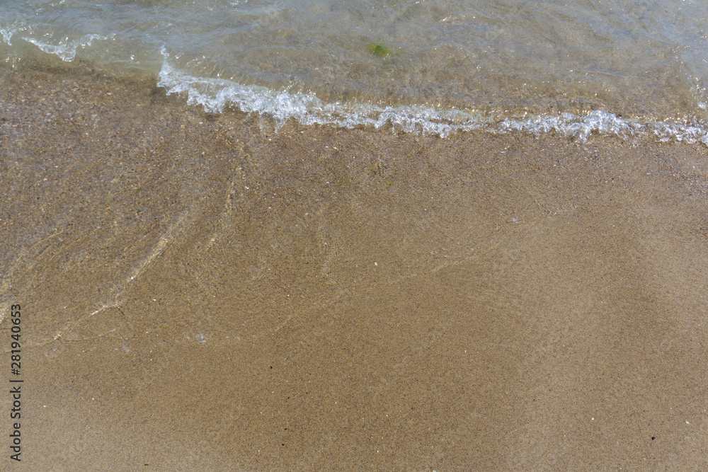 Beach close-up: sand and waves