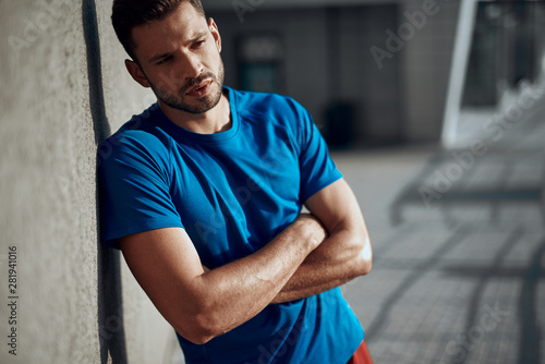 Sporty young man is resting after training