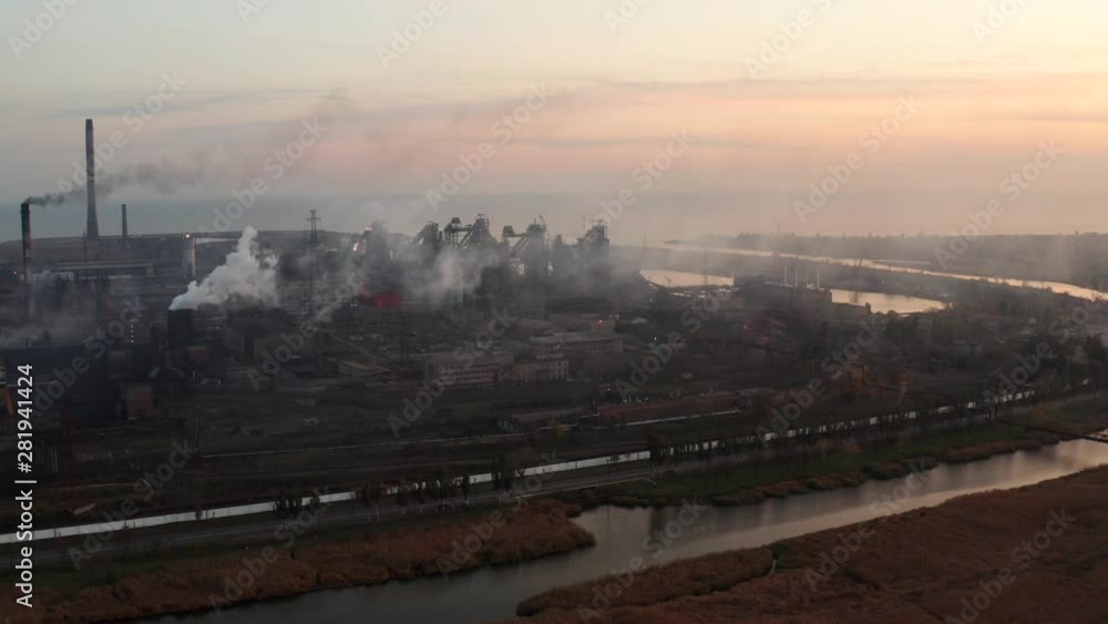 Blast furnaces on the seashore and river. Evening time. Environmental pollution. Aerial view Blast furnaces on the seashore and river. Evening time. Environmental pollution. Aerial view