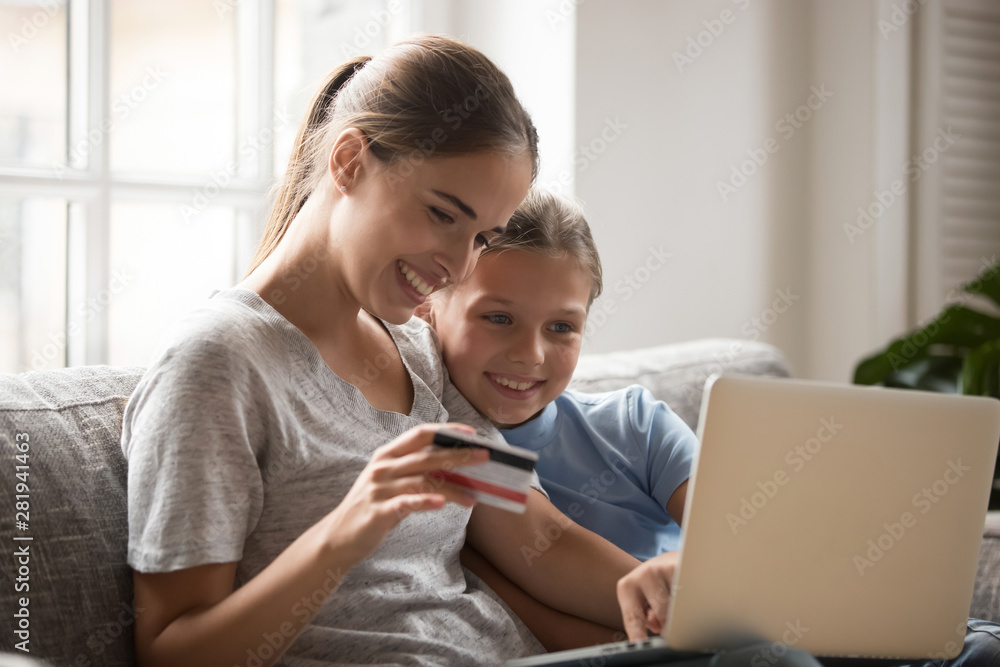 Mother and daughter using card paying money and buying online Mother and daughter using card paying money and buying online