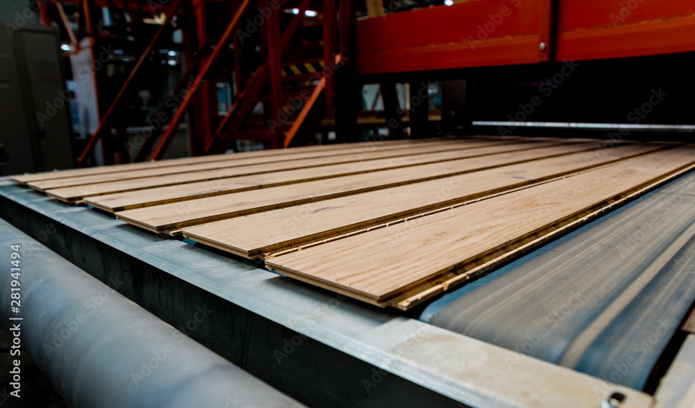 Production line of the wooden floor factory. CNC automatic woodworking machine. Production line of the wooden floor factory. CNC automatic woodworking machine.