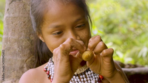 Indigenous Girl Beheading And Eating A Chontaduro Worm In Ecuador
