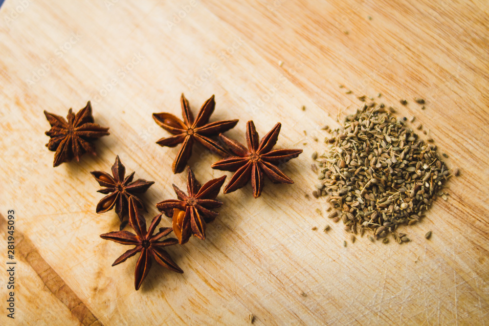 Stars anise and anise seeds in a wooden board Stars anise and anise seeds in a wooden board
