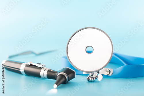 Ear professional instrument on blue background. photo