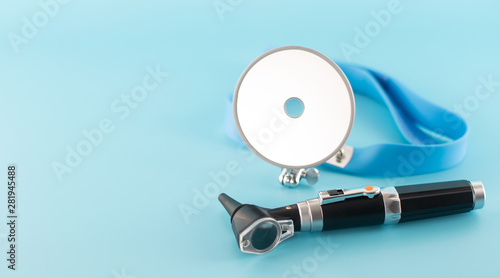 Ear professional instrument on blue background. photo