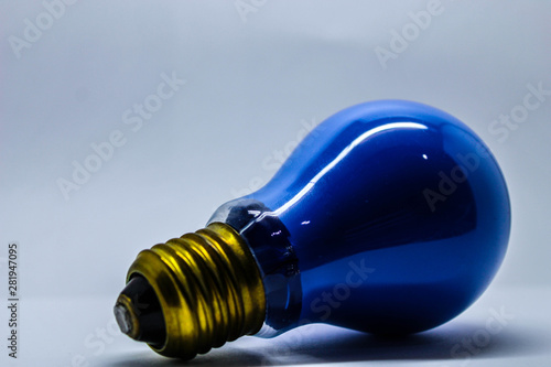 Blue light bulb on white background