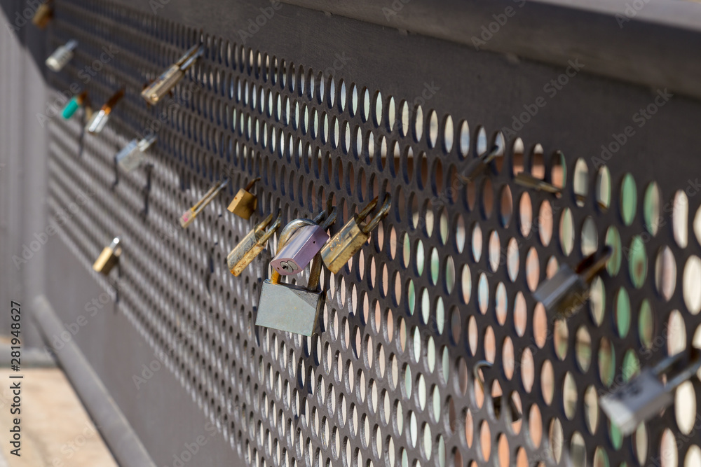 Locks of love found connected to the railing of a bridge while traveling in Malaga, Spain.