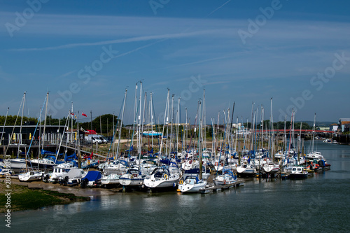 Yachts moored river arun littlehampton on the west bank outside the yacht club, on a sunny warm summers day in England in July.