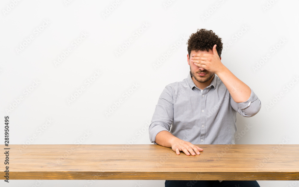 Young man with a table covering eyes by hands. Do not want to see something Young man with a table covering eyes by hands. Do not want to see something