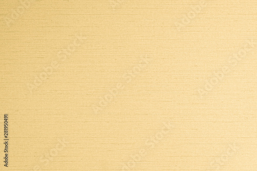 Cotton silk blended fabric wall paper texture pattern background in pastel yellow gold brown color