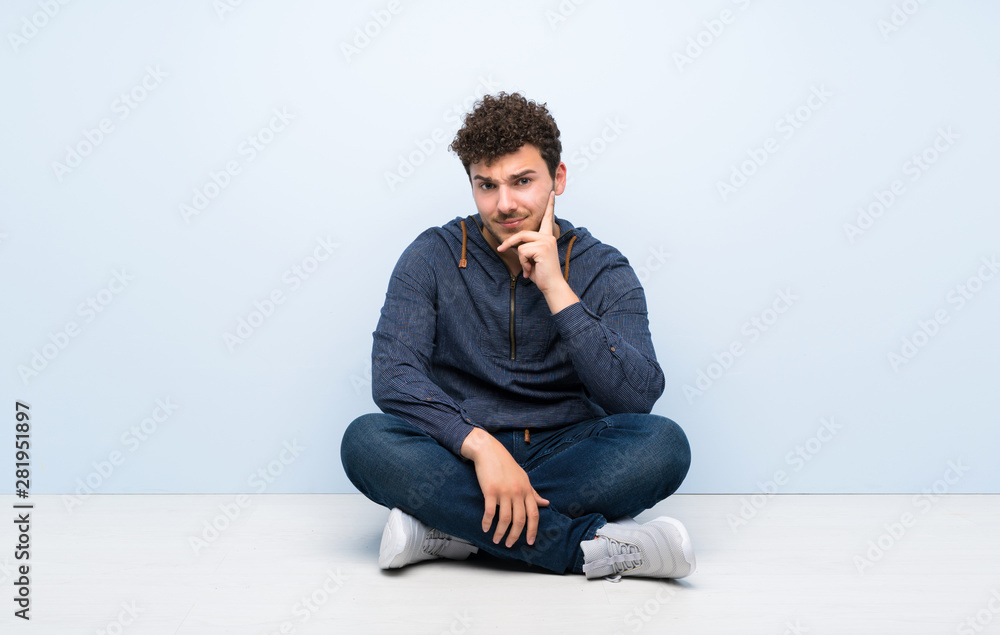 Young man sitting on the floor Looking front