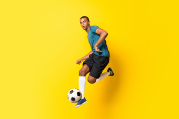 Afro American football player man over isolated yellow background