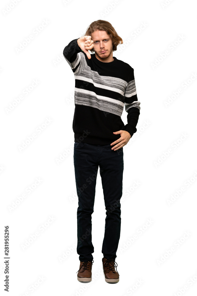 Full-length shot of Blonde man showing thumb down with negative expression over isolated white background Full-length shot of Blonde man showing thumb down with negative expression over isolated white background