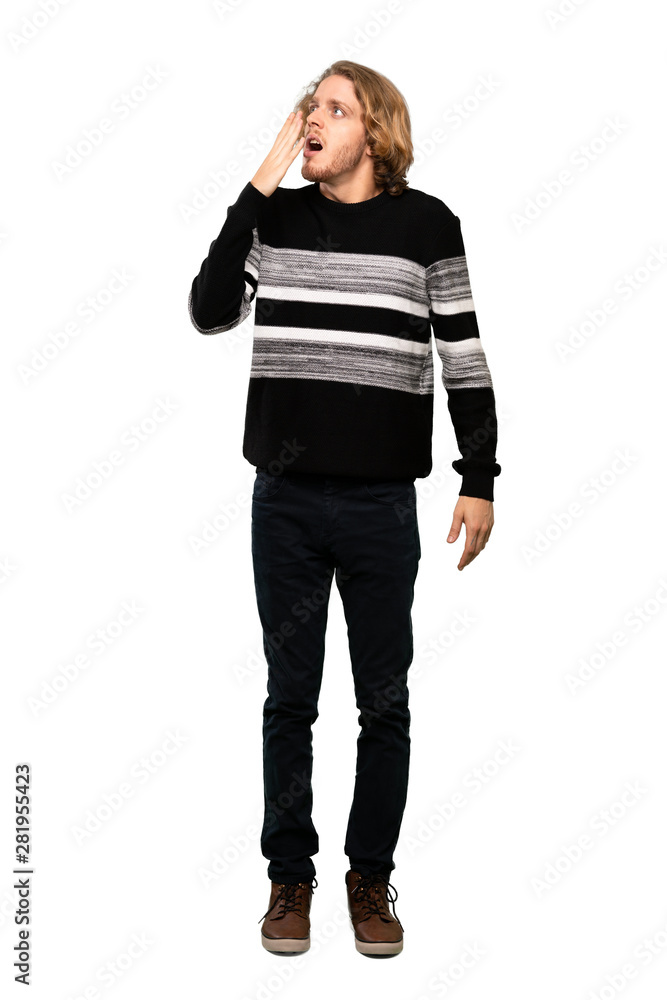 Full-length shot of Blonde man yawning and covering wide open mouth with hand over isolated white background Full-length shot of Blonde man yawning and covering wide open mouth with hand over isolated white background
