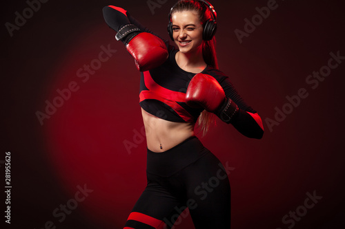 Happy and smiling young woman sportsman boxer on boxing training. Girl wearing gloves, sportswear.